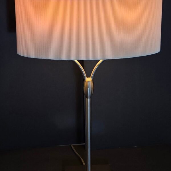 Elegant contemporary table lamp featuring a sleek brushed-metal finish