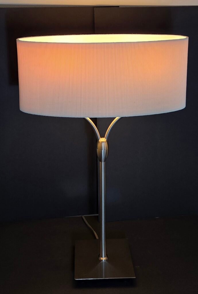 Elegant contemporary table lamp featuring a sleek brushed-metal finish