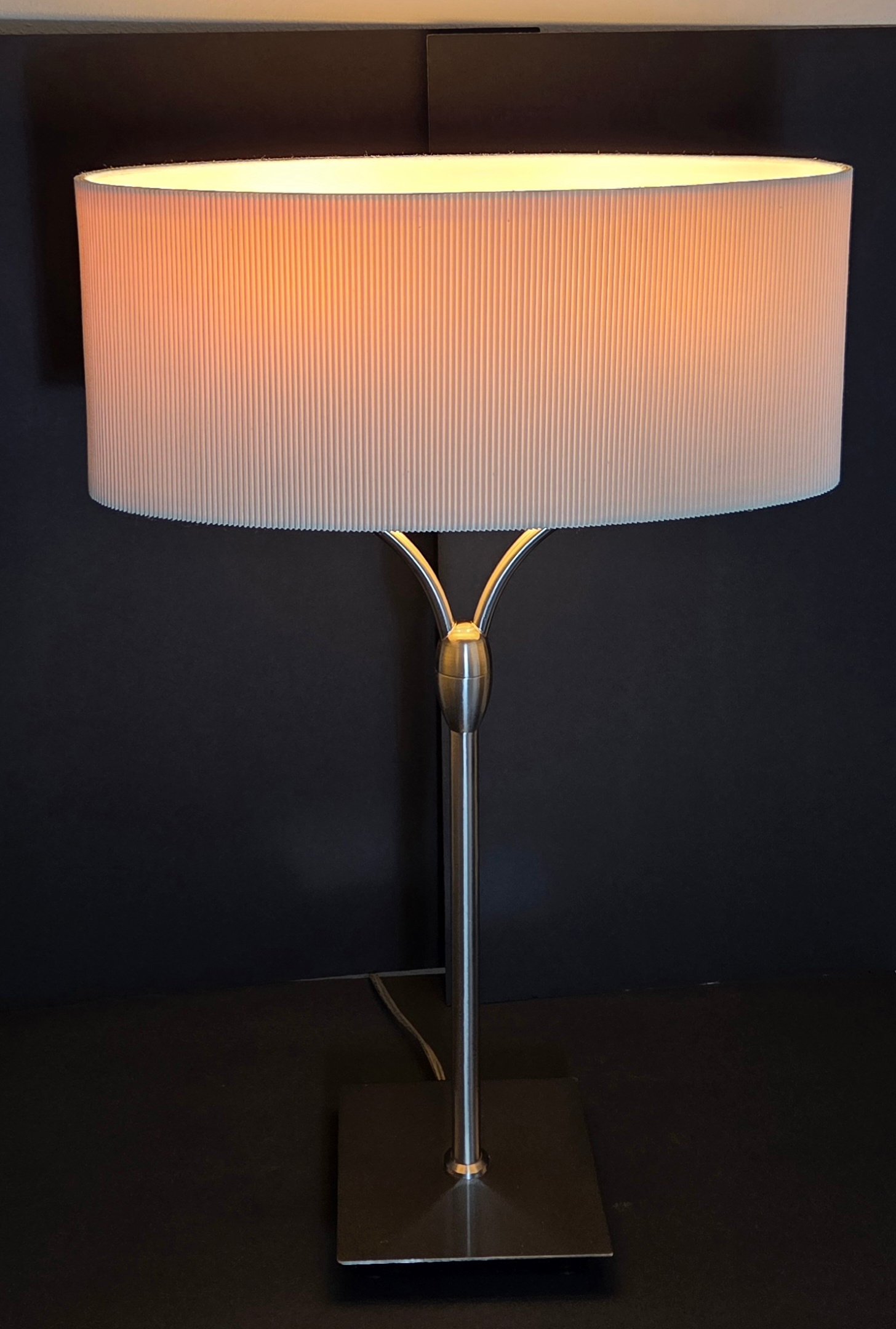 Elegant contemporary table lamp featuring a sleek brushed-metal finish